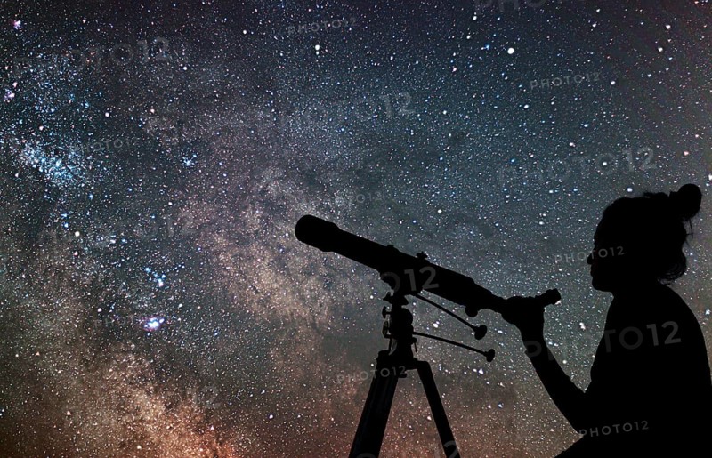 Woman with telescope watching the stars. Stargazing woman and night sky