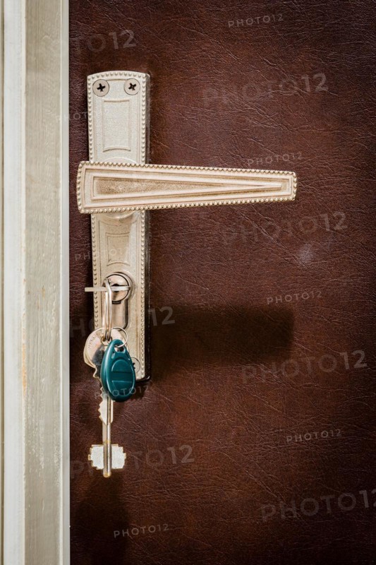 Home door. Keys are inserted in the lock of the entrance door of the apartment