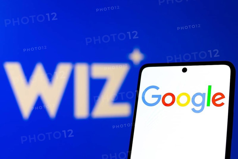 In this photo illustration, the Google logo is displayed on a smartphone screen, in the background the Wiz logo