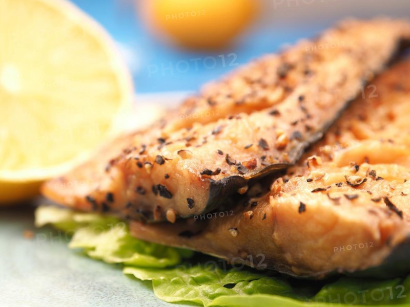 Tasty smoked mackerel garnished with pepper corns, selective focus