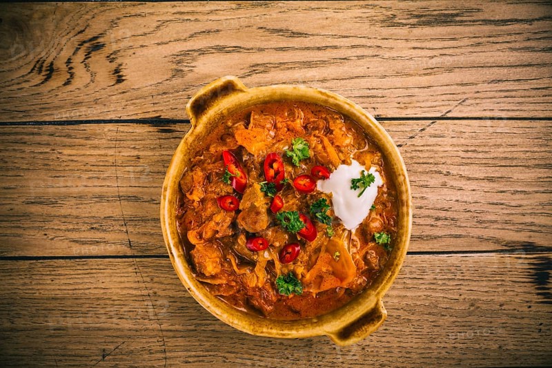 Hungarian Szegedin Goulash with pickled white cabbage (sauerkraut), onion and bread dumplings in pan