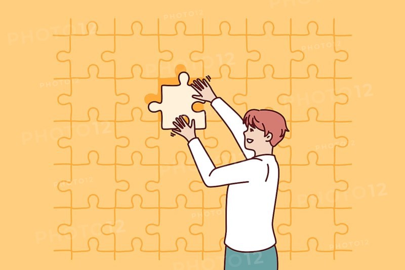 Business man putting last piece of puzzle in free space for problem solving concept. Guy in business clothes is engaged in obtaining new skills and performs complex challenge on instructions manager