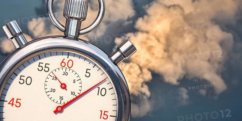 Fast reduce emissions. A stop clock with emissions in background