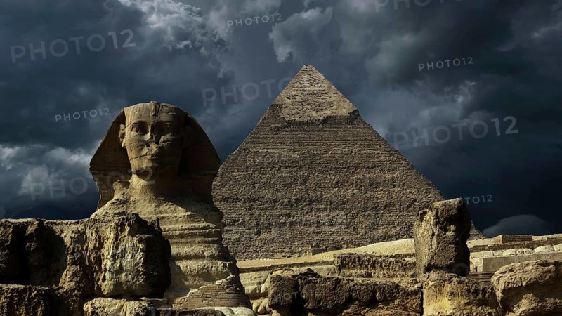 Great pyramid and sphinx and dark storm clouds in Giza Cairo, Egypt, Africa