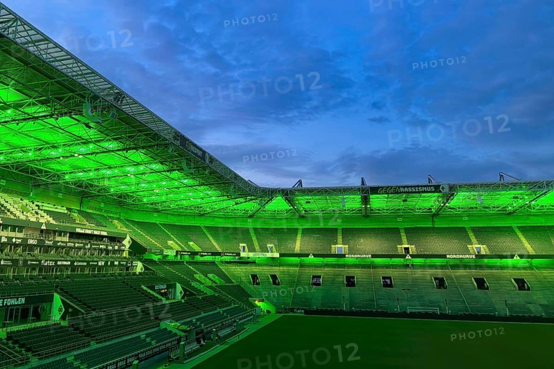 Football stadium Borussiapark without spectators, illuminated in green, sunset, Mönchengladbach, Germany, Europe