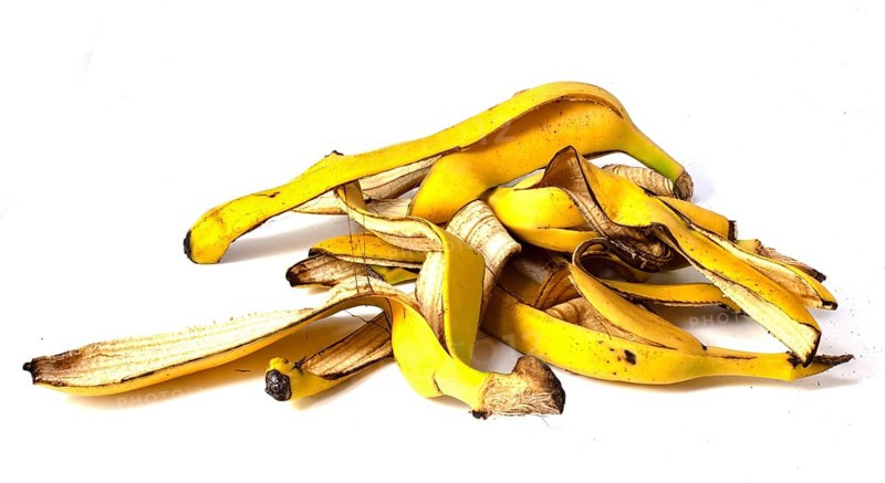A pile of banana peels, organic fruit waste on a white background