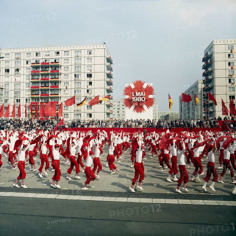 198005010101, East Berlin, 01.05.1980, Karl-Marx-Allee, sportswomen with scarves during a demonstration in front of the honour stage at the May Day demonstration East Berlin, GDR GDR