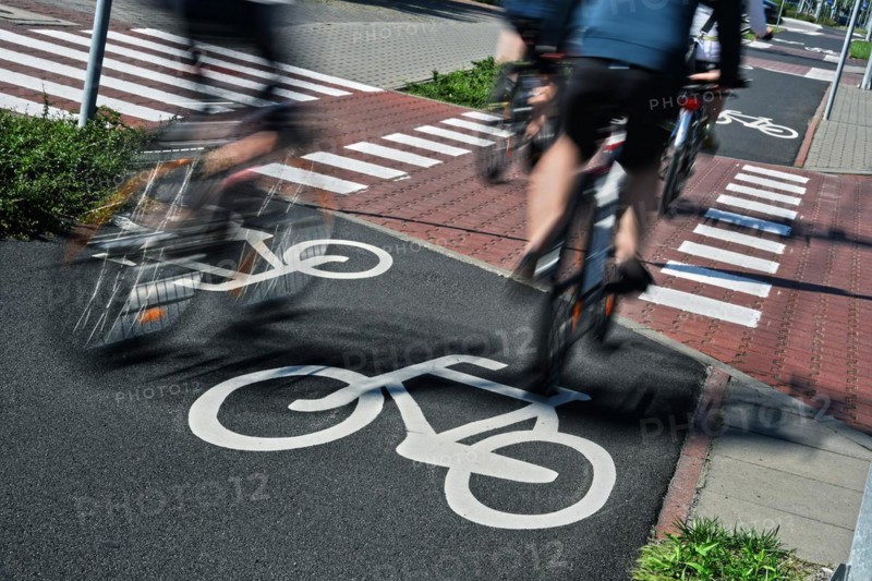 Bicycle road sign and bike riders