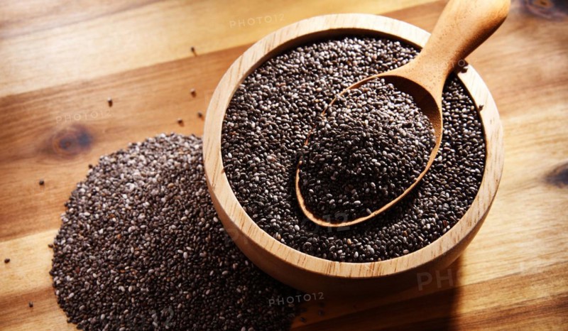 Bowl of chia seeds on wooden table