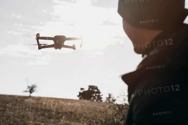 Close up man watching drone. Beautiful photo