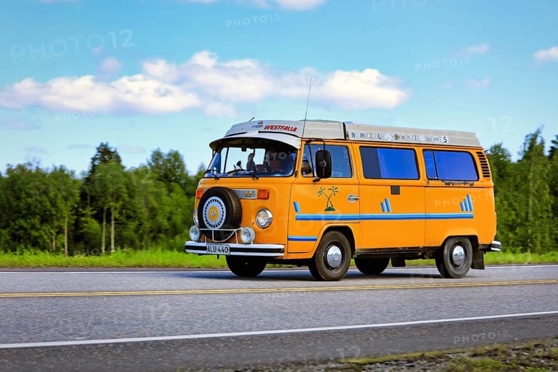Classic yellow Volkswagen Westfalia camper van at speed on Highway 2 on a beautiful day of summer. Forssa, Finland. July 31, 2020