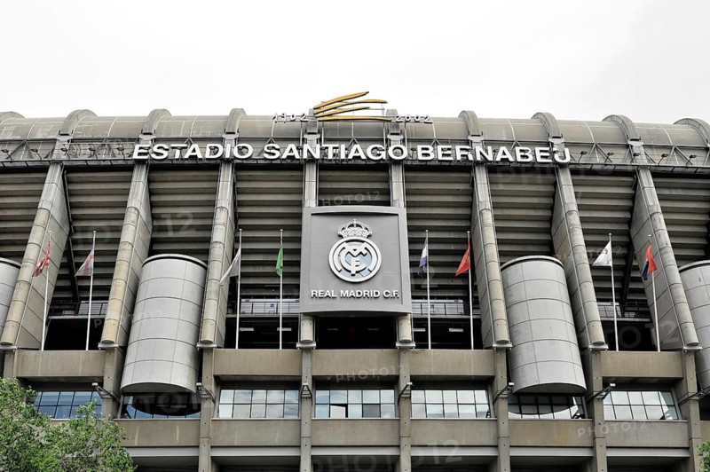 Estadio Santiago Bernabéu, football stadium of the Spanish club Real Madrid, 80354 seats, Madrid, Spain, Europe, The main facade of the Santiago Bernabéu stadium with the Real Madrid crest and several flags, Europe