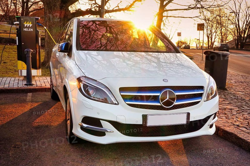 Mercedes-Benz B-Class Electric Drive electric car plugged in at public HELEN charging point. Helsinki, Finland. April 18, 2021