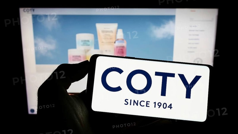 Stuttgart, Germany, 10-03-2022: Person holding cellphone with logo of US beauty company Coty Inc. on screen in front of business webpage. Focus on phone display, Europe