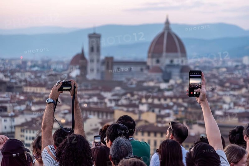 FLORENCE, ITALY, SEPTEMBER 21, 2023, Large tourist crowd on Piazzale Michelangelo enjoying sunset over Florence, Italy, Europe
