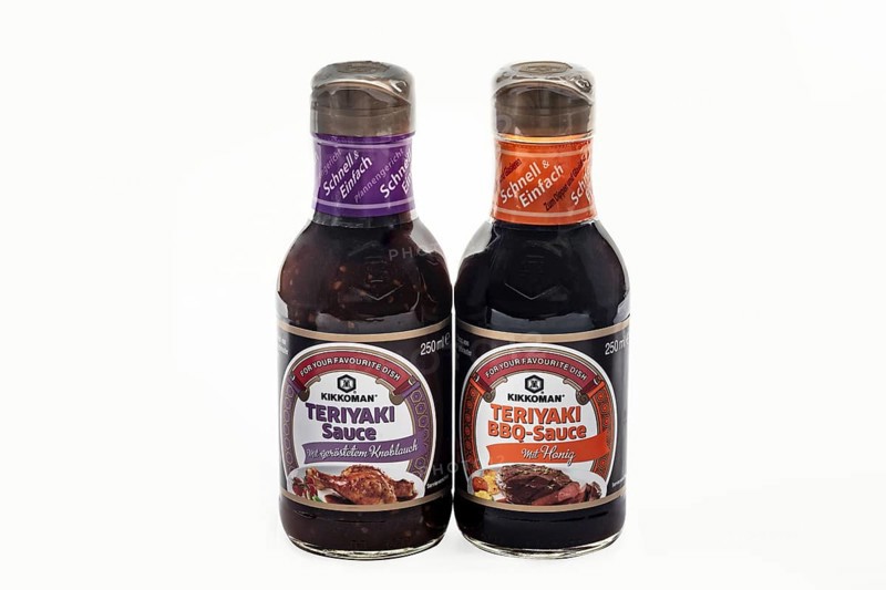 WETZLAR, Germany - 2022-07-17: Two Bottles of Kikkoman Teriyaki Sauce. In 1917 the Japanese Mogi and Takanashi families founded Noda Shoyu Co. Ltd. The company name was changed to Kikkoman Shoyu Co. in 1964 and to Kikkoman Corporation in 1980