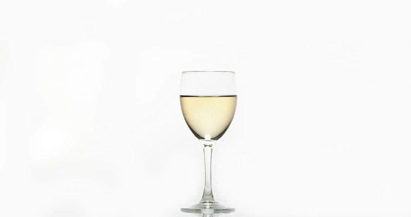 Glass of White Wine against White Background
