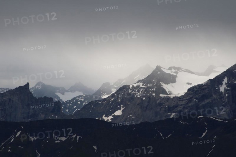 Mountains near of the Grimsel mountain pass, Bernese Oberland. View from Mount Brienzer Rothorn. Rainy, dark day