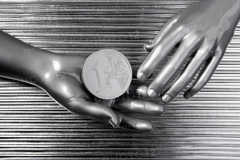 Silver euro coins in futuristic robot gray metallic hands bank metaphor