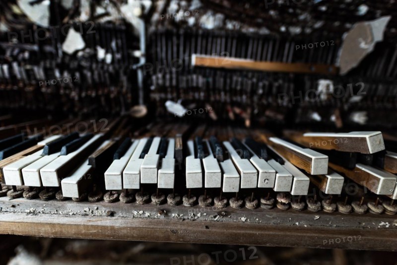 Detail of broken grand piano in mess hall of abandoned military base in Chernobyl Exclusion Zone of Alienation