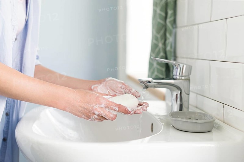Side view person using bar soap wash their hands