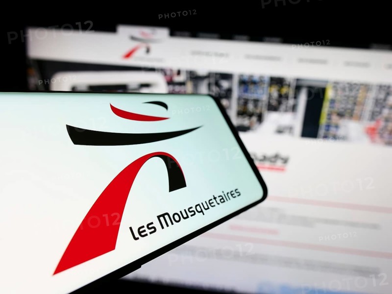 Stuttgart, Germany, 12-08-2023: Smartphone with logo of French company ITM Entreprises S.A. (Les Mousquetaires) in front of website. Focus on center-left of phone display, Europe