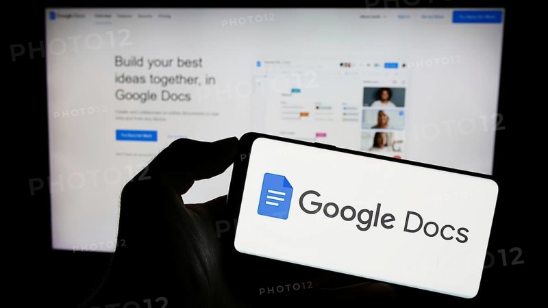 Stuttgart, Germany, 09-23-2023: Person holding mobile phone with logo of online word processing product Google Docs on screen in front of web page. Focus on phone display, Europe