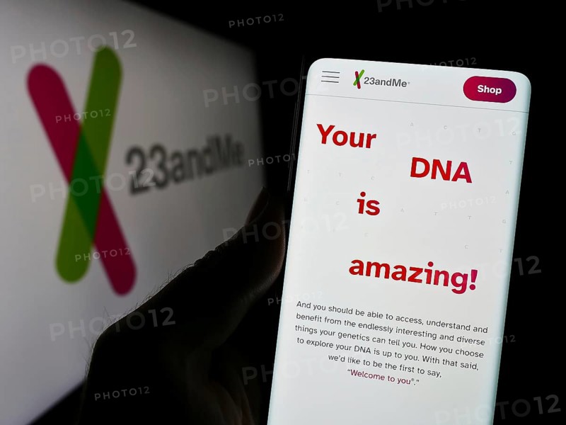 Stuttgart, Germany, 11-03-2023: Person holding cellphone with webpage of US biotechnology company 23andMe Inc. in front of business logo. Focus on center of phone display, Europe