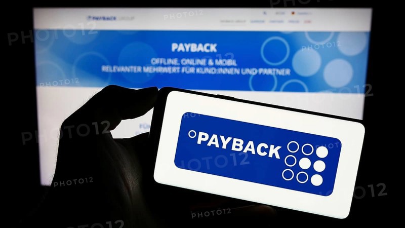 Stuttgart, Germany, 09-01-2023: Person holding cellphone with logo of German loyalty management company Payback GmbH on screen in front of webpage. Focus on phone display, Europe