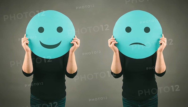 Head with a sad and a happy face, mental health concept, positive and negative mindset, depression, support and evaluation symbol, emotion
