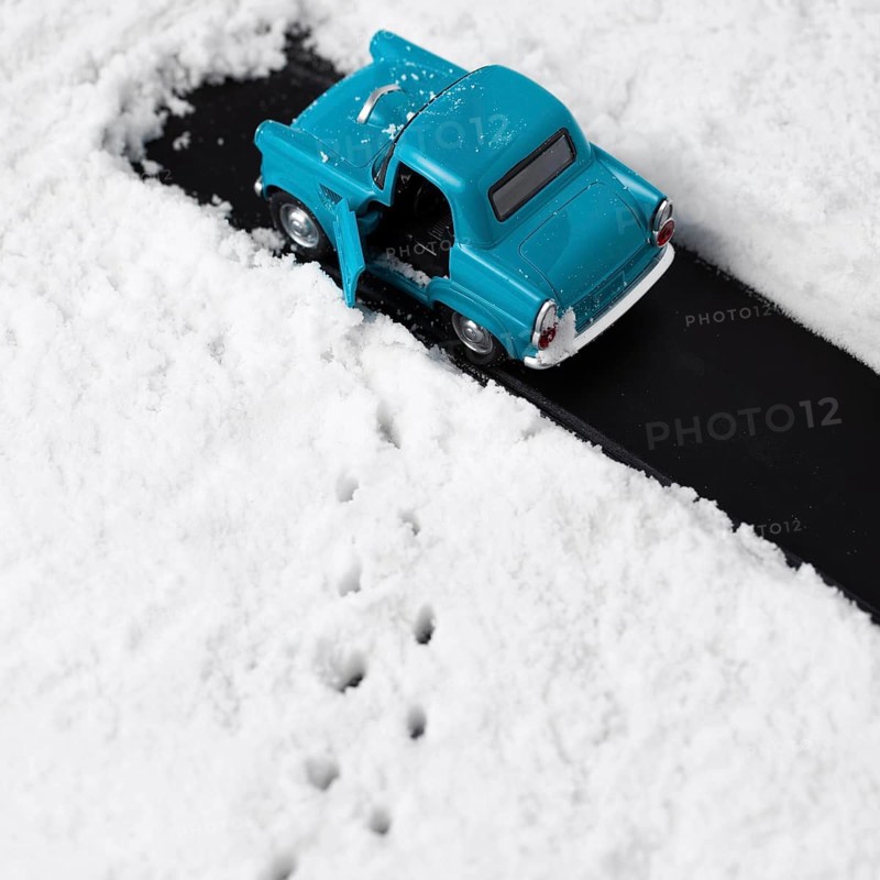 Close up view blue toy car with snow