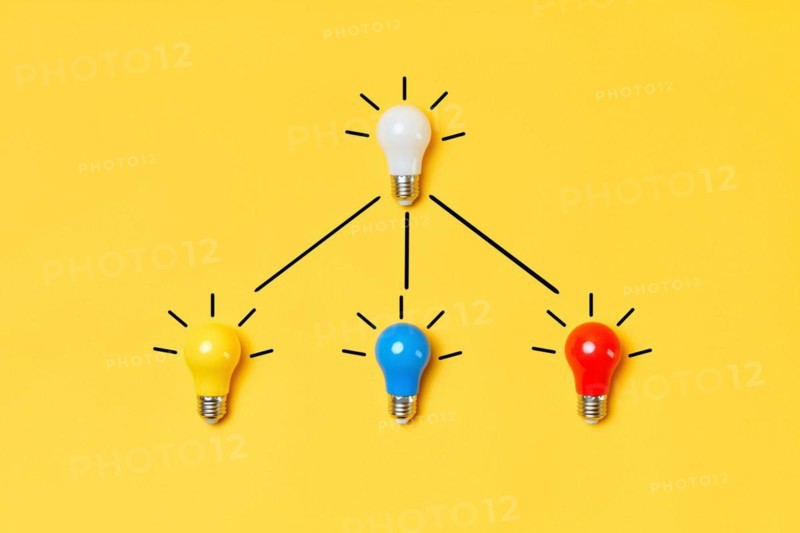 Creative layout with multicolored lightbulbs on yellow background. Idea symbol, business creativity, inspiration and motivation for success