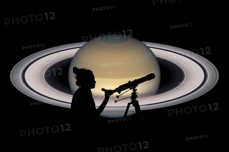 Girl looking at the stars with telescope. Saturn planet, isolated on black. Elements of this image are furnished by NASA