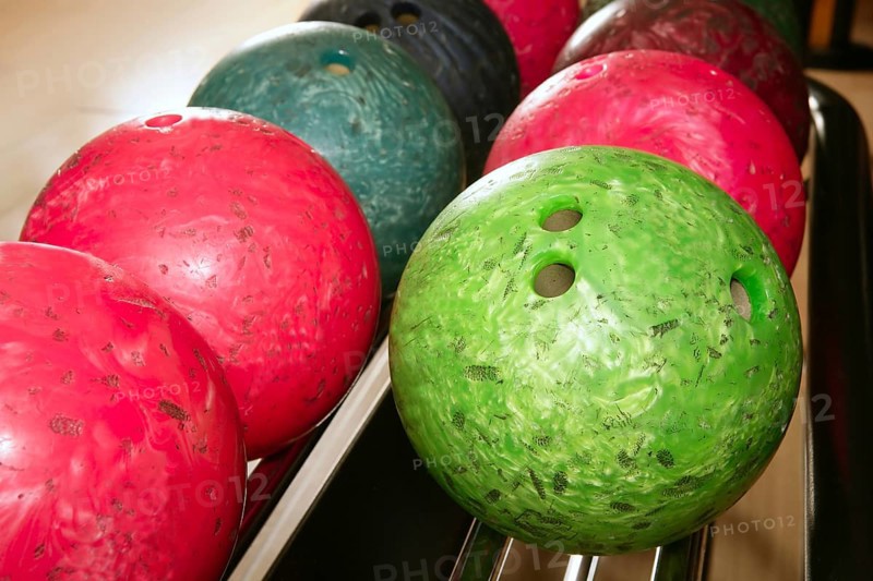 Bowling balls red green closeup row detail