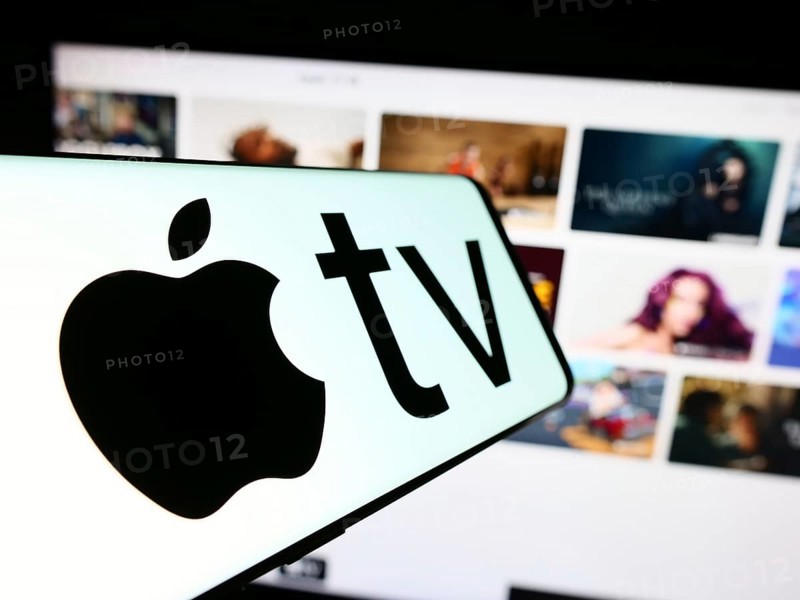 Stuttgart, Germany, 09-23-2023: Smartphone with logo of video streaming service Apple TV plus on screen in front of business website. Focus on center-left of phone display, Europe