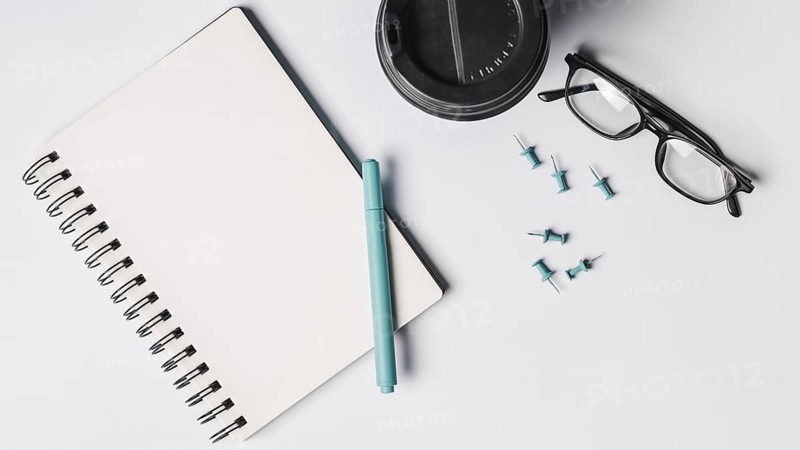 Blank spiral notepad pen coffee cup eyeglasses pushpins white background. Resolution and high quality beautiful photo