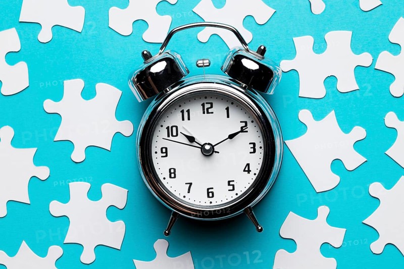 Retro alarm clock jigsaw puzzle pieces blue backdrop