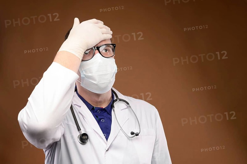 Male Caucasian doctor in white medical uniform shows face palm gesture. Chagrin and disappointment. Copy space