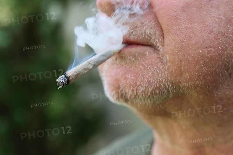 A man smokes a joint