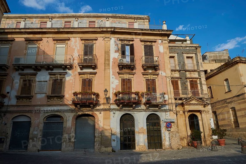 Historic building with worn balconies and shutters on a quiet street, Ortigia Island, Isola di Ortigia, Historic Centre, Syracuse, Sicily, Italy, Europe
