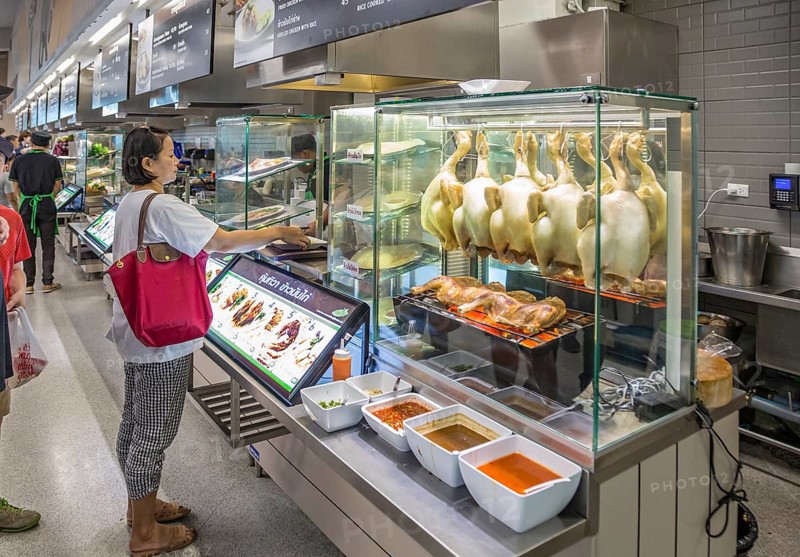 Thai woman ordering food in the cafeteria at the Big C Supercenter in Chiang Rai, Thailand, Asia