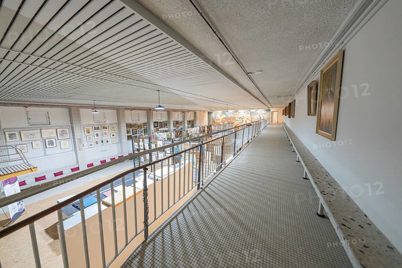 A wide corridor in a gallery with works of art on the walls and modern architectural design, historical art exhibition in the old swimming pool, Schaudepot, Calw, Black Forest, Germany, Europe