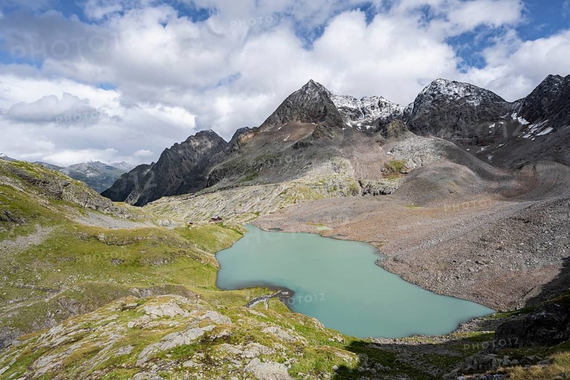 View of the turquoise-blue mountain lake Großer Gradensee, with the peaks of Petzeck and Kruckelkopf behind, Schober Group, Hohe Tauern National Park, Carinthia, Austria, Europe