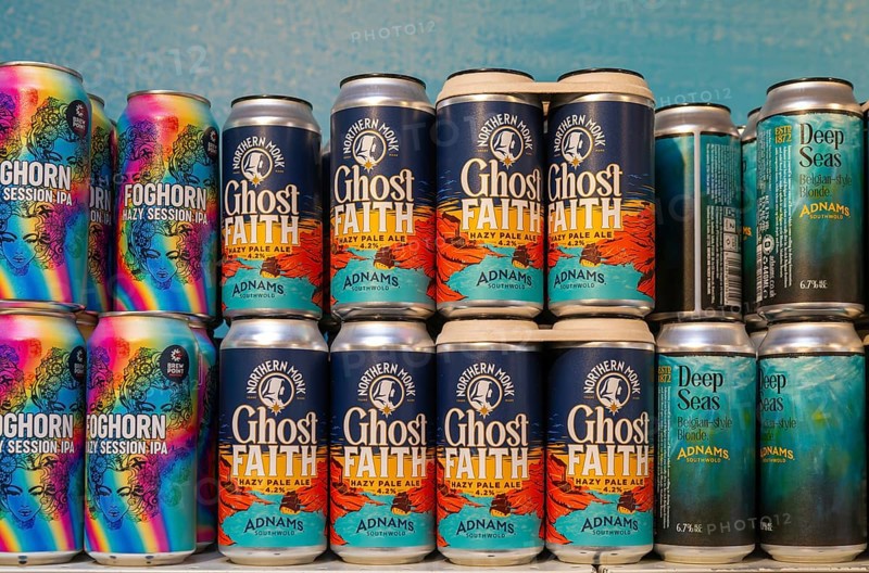 Adnams beer products on display inside brewery shop, Southwold, Suffolk, England, UK - Ghost Faith hazy pale ale cans