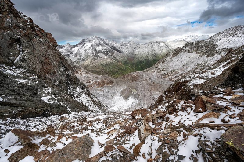 View of steep rocky mountain landscape with fresh snow in summer, in the Hornscharte, on the Wiener Höhenweg, behind summit Roter Knopf, Schober group, Hohe Tauern National Park, Carinthia, Austria, Europe