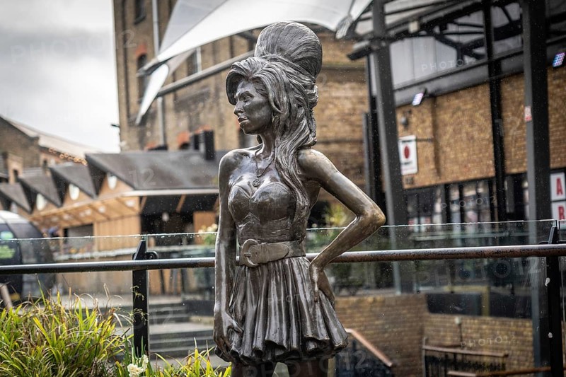 Bronze statue of the late singer amy winehouse, standing proudly in stables market, camden town, london