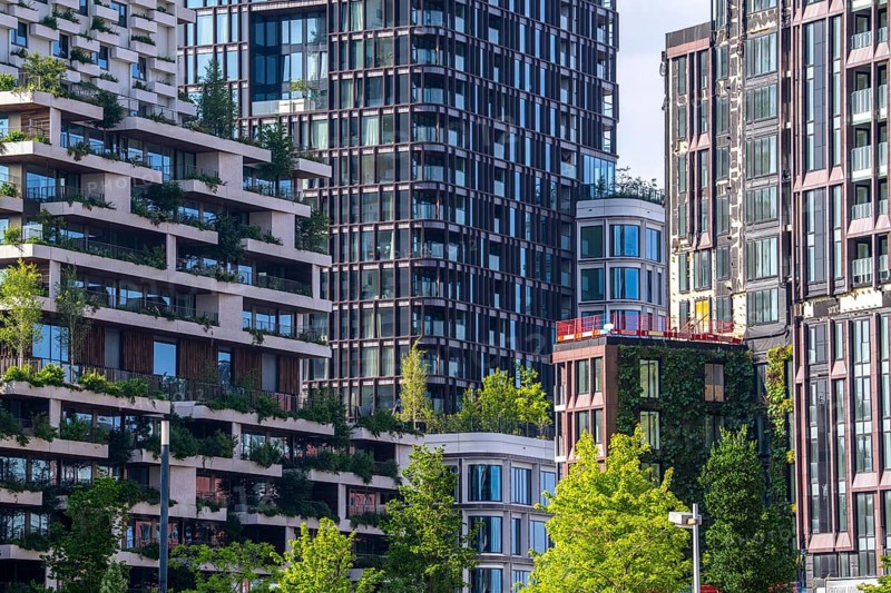 Residential tower Wonderwoods, 2 green buildings, in Utrecht in the new Healthy Urban Quarter, at the Central Station, 105 metres high with 30 floors, Tower II, rear, Tower I, front, 70 metres high, over 360 trees and over 9600 shrubs and flowering plants native to the region, all irrigated with collected rainwater, sponge city principle and monitored with sensors, Utrecht, Netherlands