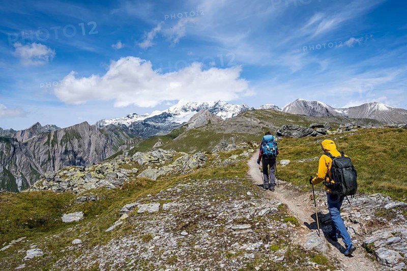 Mountaineers on a hiking trail, view of picturesque mountain landscape with snow-covered summit of the Großglockner, Vienna High Trail, Schober Group, Hohe Tauern National Park, Carinthia, Austria, Europe