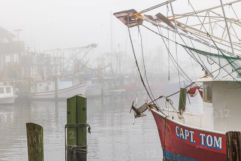 Commercial shrimp boats at the dock in the commercial area of the Biloxi Small Craft Harbor in Biloxi, Mississippi