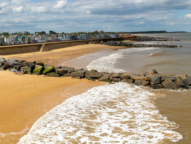 View north of sandy beach and coastal defences from pier, Southwold, Suffolk, England, UK
